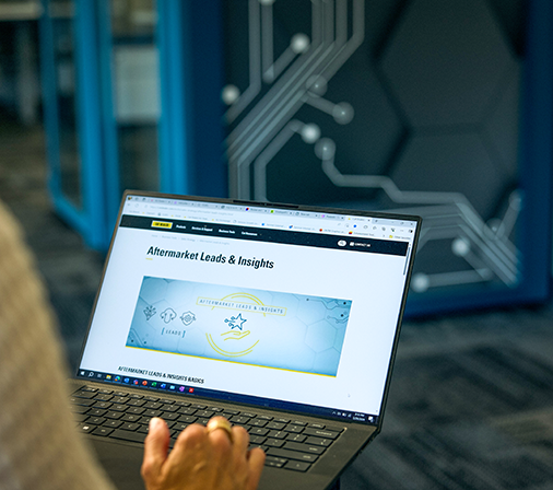 a laptop that reads "aftermarket leads & insights"