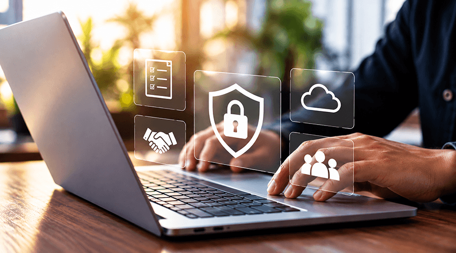 Person using a laptop with cybersecurity icons.