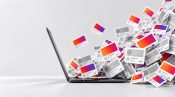 Laptop surrounded by digital content cards.