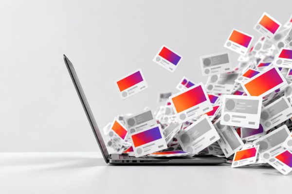 Laptop surrounded by digital content cards.