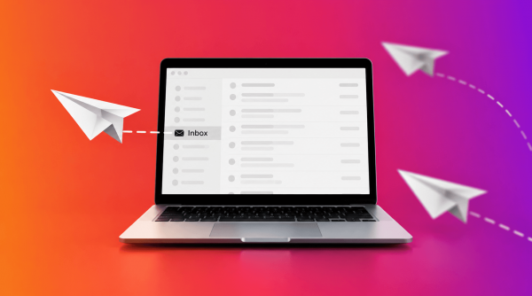 Laptop displaying an email inbox with paper airplanes.