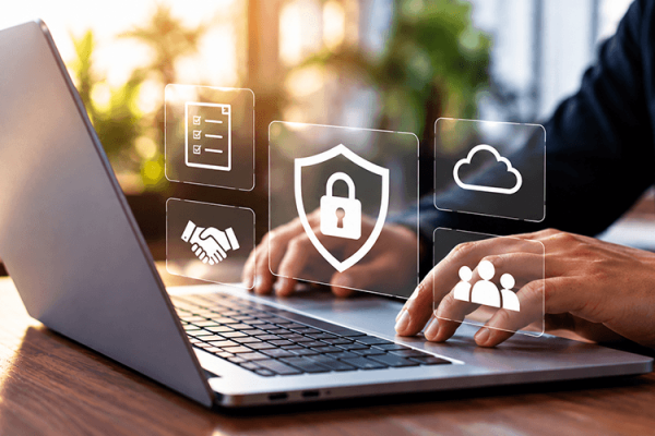 Person using a laptop with cybersecurity icons.